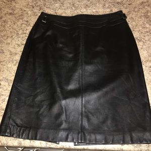 Black leather mid length skirt.